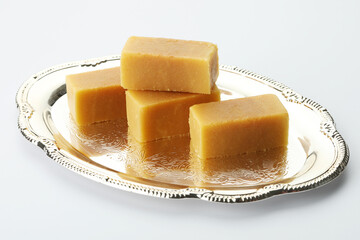 Mysore pak, a traditional, popular, and delicious sweet dish native to the city of Mysore, Karnataka, India, is made from ingredients like gram flour, ghee and sugar