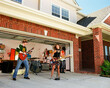 © SuperStock - Group of Friends in garage band practicing in driveway in front of home