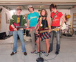 © SuperStock - Group portrait of Friends in garage band after practicing in driveway in front of home