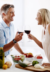 Sticker - Lets toast to cooking. Cropped shot of an affectionate mature couple toasting with red wine while making dinner.