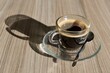 © SuperStock - Transparent Cup of Coffee with Shadow on Wood Table in Switzerland.