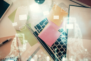 Aufkleber - Envelop hologram drawing over computer on the desktop background. Top view. Double exposure. Technology concept.