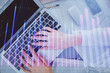 © peshkova - Double exposure of woman hands working on computer and forex chart hologram drawing. Top View. Financial analysis concept.