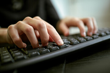 Female hands or woman office worker typing on the keyboard