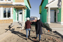 Female Engineers Inspecting New Houses In Construction Development