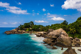 Fototapeta Boho - Aerial photo over Seychelles displaying the natural unspoilt beauty of the islands - from the crystal clear oceans to the lush green forests and granite boulders cascading on the white beaches. 