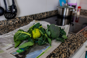 Wall Mural -  green organic green cauliflower and broccoli on a kitchen countertop in close-up