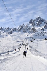 Wall Mural - People going up to the mountain on a drag lift