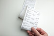 A long store receipt in hand, food expenditure analysis