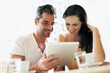 © Nicola K/peopleimages.com - Using the wi-fi with my wifey. Shot of a young couple using their tablet during a coffee date.