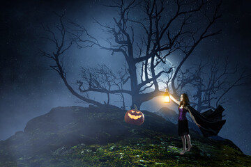Wall Mural - beautiful young woman in witches hat and costume