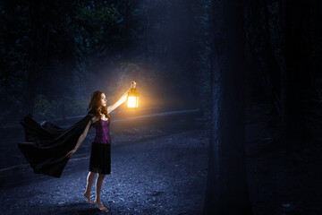 Wall Mural - beautiful young woman in witches hat and costume