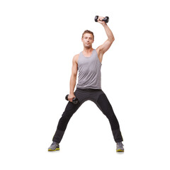 Wall Mural - Toning his arms. A fit young man working out with dumbbells while isolated on a white background.