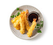 Shrimp tempura on a plate placed on a white background.