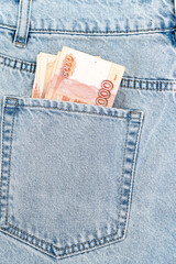 Wall Mural - banknotes in the pocket of blue jeans. cash turnover. russian 5000 banknote