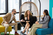 © winnievinzence - Group of diversity businesspeople discussing at couch in the office. man and woman enjoy talking at co-working space. brainstorming business, sharing story or small talk.