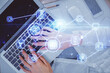© peshkova - Double exposure of woman hands working on computer and social network theme hologram drawing. Top View. People connection concept.
