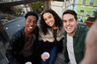 © StratfordProductions - Group of multi-cultural young adults smiling while taking a selfie. At a rooftop party in the city, good times.