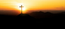 Religious Grief Landscape Background Banner Panorama - Breathtaking View With Black Silhouette Of Mountains, Hills, Forest And Cross / Summit Cross, In The Evening During The Sunset Or Sunrise