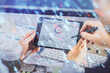 © peshkova - Multi exposure of man's hands holding and using a digital device and data theme drawing. Innovation concept.