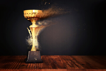 Wall Mural - image of gold trophy over dark background