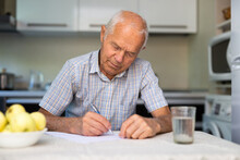 The Old Man Is Writing A Letter On The Table