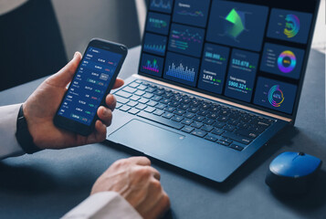 Stock market investment. Trader or broker analysing graphic
cryptocurrencies and stocks  financial data on phone.Financial Technology. Business strategy and digital marketing concept.	