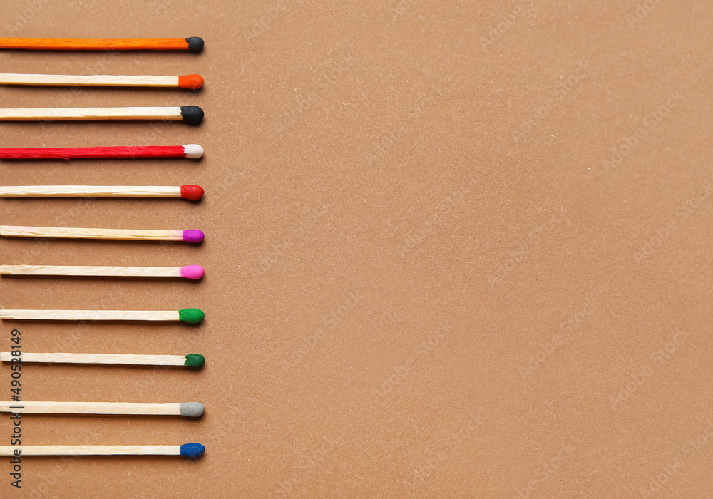 Different new matchsticks on brown background