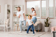 © Pixel-Shot - Happy young family listening to music at home