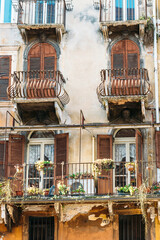 Wall Mural - Verona, Italy - windows of an old palace in the Piazza delle Erbe