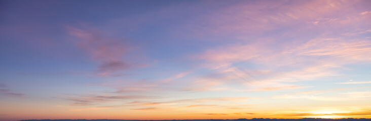 Wall Mural - Beautiful Panoramic View of colorful cloudscape with blue Sky in Background during a sunny winter sunset. Taken in Vancouver, British Columbia, Canada.