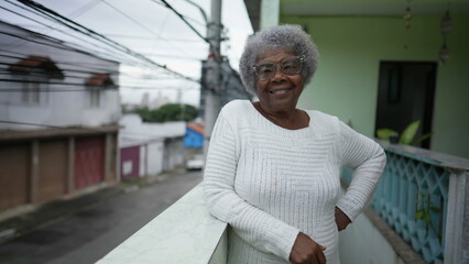 Wall Mural - A black senior woman portrait standing outside smiling at camera