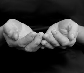 praying to god with hands together with dark background stock photo