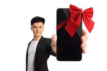 Canvas Print - Full length portrait of a fashionable guy showing a smartphone with red ribbon in front of camera