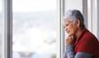 © Mapodile M./peopleimages.com - Lost in thought. Shot of a mature woman standing by a window on a sunny day.