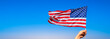 American flag with female hand. Banner with blue sky