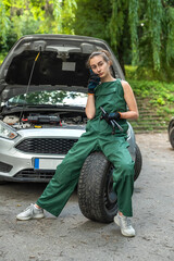 Wall Mural - portrait of woman mechanic near broken down car on the road side