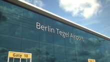 Commercial Plane Take Off Reflecting In The Windows With Berlin Tegel Airport Text