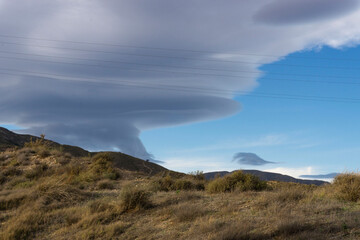 landscape with cables and cloudy sky