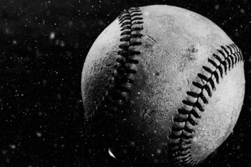 Wall Mural - Old baseball ball close up in black and white for nostalgic sports background in shallow depth of field.