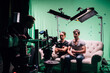 © Anna - Professional male actors work in the frame on the set. Shooting with actors on a big green chroma key.