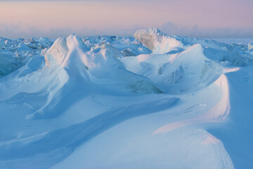 Wall Mural - Winter arctic landscape. Ice hummocks on the frozen sea in the Arctic. View of snow and ice at sunset. Cold frosty winter weather. Harsh polar climate. Amazing nature in the far north in the Arctic.