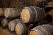 © barmalini - Medieval underground wine cellars with old red wine barrels for aging of vino nobile di Montepulciano in old town Montepulciano in Tuscany, Italy