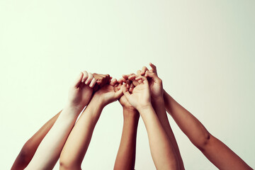 Poster - Hold on tight. Cropped shot of a group of people holding each others thumbs with their hands raised.
