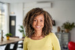 © CarlosBarquero - Portrait of a beautiful young adult woman smiling. African girl in casual looking at camera with. Cheerful mixed race relaxing at home with big laugh.