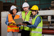 © tigercat_lpg - Safety uniform workers and industrial engineers with hardhat use laptop computer to check and control machines. Three professionals work in paper manufacturing factory, maintain production equipment.