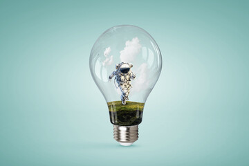 Wall Mural - spaceman inside light bulb . mixed media
