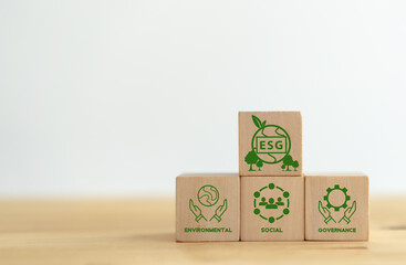 Canvas Print - ESG concept of environmental, social and governance. Sustainable corporation development. Hand holds wooden cubes with abbreviation ESG standing with other ESG icons on white background. Copy space.