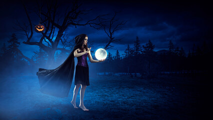 Wall Mural - beautiful young woman in witches hat and costume