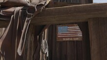 This Video Shows An Old Western "in God We Trust" American Flag Sign, Behind A Saddle On A Western Style Household Door.